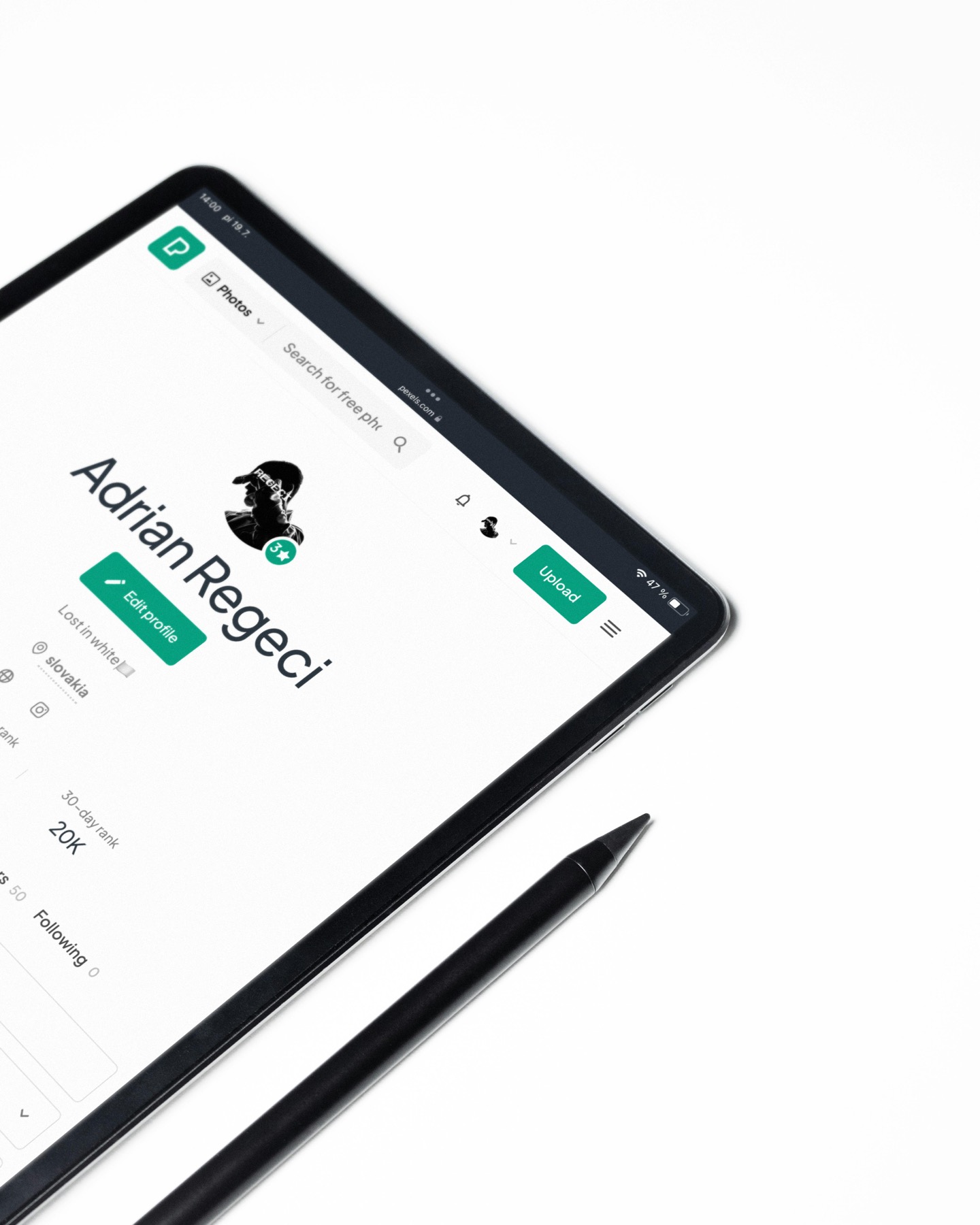 A minimalist tablet and stylus on a white surface, representing clean planner setup.